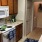 Kitchen area with white stove and wooden cabinets