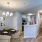 Dining room and kitchen featuring three chairs, one table, and a chandelier