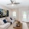 Modern living room with blue and white themed sofas and artwork on the wall